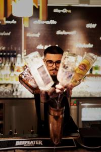 a man is holding up two containers of food at Holzhotel Forsthofalm in Leogang +37 photos
