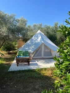 a tent with a bed in front of it at Eco Glamping with Pool between Nafplio and Argos in Argos