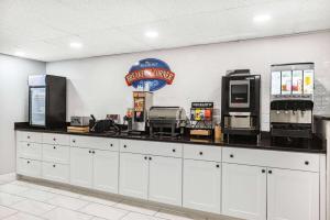 a counter in a fast food restaurant with aperature at Baymont by Wyndham Gillette in Gillette