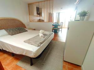 A bed or beds in a room at VILLA FALCONERA APARTAMENTS, GANDIA a las faldas de la montaña