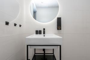 a bathroom with a white sink and a mirror at SETO MAN Puhkekeskus in Värska