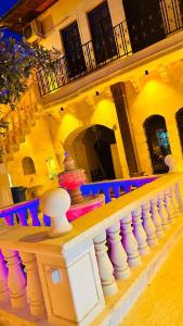 a building with a white railing with purple lights at Serce Konagi in Urfa