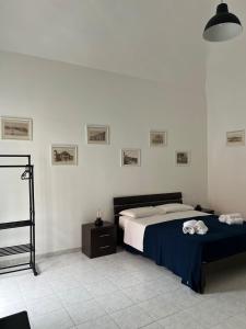 a bedroom with a large bed with a blue blanket at Casaurora Centro Storico in Catania