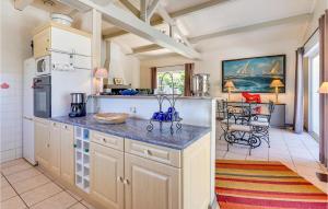 a kitchen with a counter top and a refrigerator at Lovely Home In Sainte-Marie-De-Ré in La Flotte