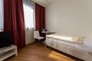 A bed or beds in a room at Hotel Sommerhaus Linz