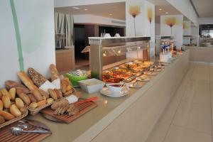 a buffet line with many different types of food at Nelia Beach Hotel & Spa in Ayia Napa