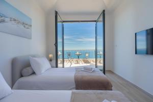 a bedroom with a bed and a view of the ocean at Villa Krstac in Budva +100 photos