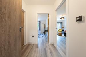 a hallway with a door leading to a living room at Ashview 6 - Heathrow - Windsor - Free Parking in Staines upon Thames