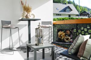 a patio with a fireplace and a table and chairs at Studio Vilawin Kranjska Gora in Kranjska Gora