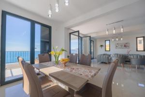 a dining room with a table and chairs at Villa Krstac in Budva