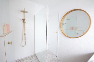 a bathroom with a shower and a mirror at Luxury hideaway holiday unit in CBD in Mount Gambier