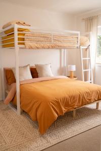 a bedroom with a bunk bed with an orange blanket at Luxury hideaway holiday unit in CBD in Mount Gambier