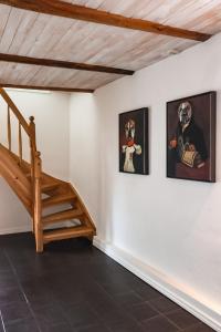 a staircase in a room with three paintings on the wall at Ludvigsdal Semesterboende in Ystad
