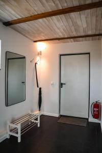 a room with a mirror and a white door at Ludvigsdal Semesterboende in Ystad