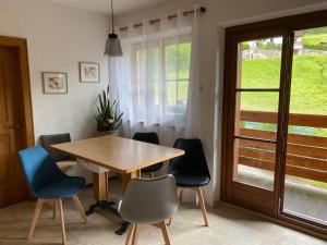 a dining room with a wooden table and chairs at Schneiderhaus in Bagni di Lavina Bianca