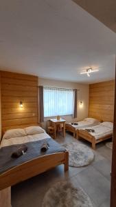 a bedroom with two beds and two tables in it at U Bizioma in Murzasichle