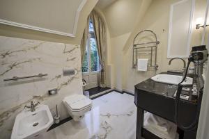 a bathroom with a sink and a toilet at Wilson Palace in Bratislava