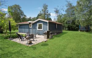 a shed with a picnic table and chairs in a yard at 2 Bedroom Gorgeous Home In Vordingborg in Vordingborg