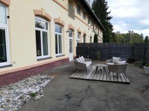 a patio with two chairs and a table in front of a house at Exklusives Studio / Loft / Atelier Red Bull Ring Airpower Moto GP in Fohnsdorf