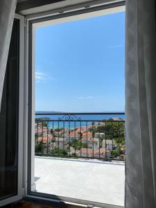 a view of the ocean from a window at D&M APARTMENTS in Rab