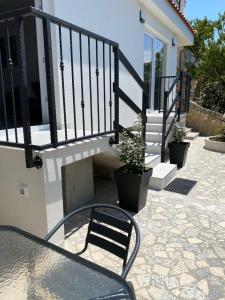 a table and a chair sitting on a patio at D&M APARTMENTS in Rab