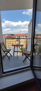 a table and chairs on a balcony with a view at Brand new two room apartment #64 in Elite Rezidence with free secure parking in Prague