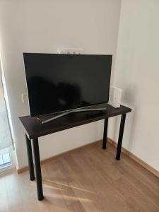 a television sitting on a table in a room at Prie Vilneles Apartment in Vilnius