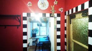 a room with a clock on the wall and a table at Picturesque apartment into antique fortress in Daugavpils