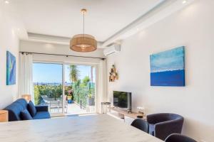 a living room with a large table and chairs at #43 Design Studio Terrace AC Wifi Sea View 1min Beach in Nice