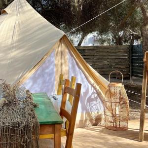 ein Zelt mit einem Tisch und einem Stuhl im Hof in der Unterkunft PARADISO DEL MARE in Fontane Bianche