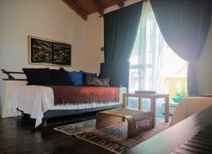 a bedroom with a bed and a large window at Beautiful Vintage House in Vis