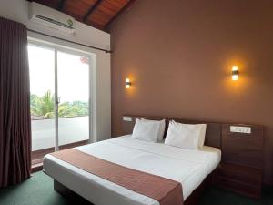 una camera da letto con un letto con una grande finestra di The SkyDeck Kandy a Kandy