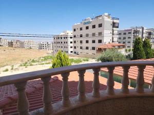 a balcony with a view of a city at Shafa Badran apt in Amman
