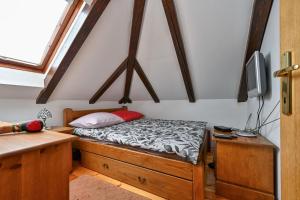 a small bedroom with a bed and a tv at Hunting Lodge - Happy Rentals in Ribnjačka
