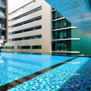 a swimming pool in front of a building at D'CASA Riverson at Kota Kinabalu in Kota Kinabalu