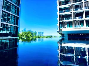 two tall buildings next to a body of water at D'CASA Riverson at Kota Kinabalu in Kota Kinabalu