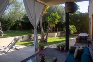 a patio with a couch and a table and a table at Casa Boticario in Mairena del Aljarafe