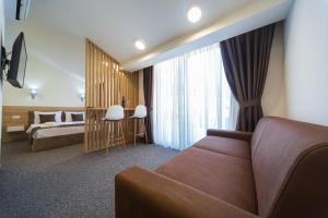 a hotel room with a couch and a bed at Rooftop apartments & rooms Budva in Budva