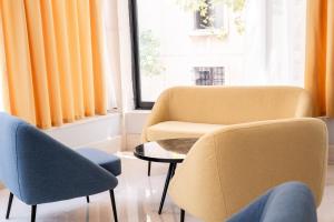 a living room with two chairs and a table at Island City Boutique Hotel in Rhodes Town