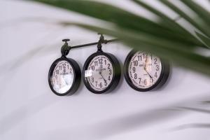 two clocks are hanging on a wall at Island City Boutique Hotel in Rhodes Town