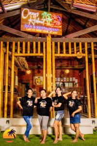 a group of women standing in front of a bar at Loboc Cool River Resort in Loboc