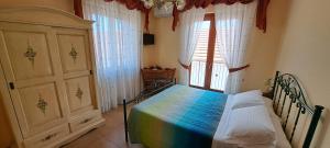 a bedroom with a rainbow bed and a window at B&b Springs of Gods in Pianillo