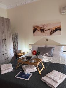 a bedroom with a bed with a table and a table at Salamis Luxury Escape in Salamís