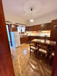 a kitchen with a table and a refrigerator at Salamis Luxury Escape in Salamís