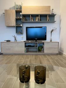 uma sala de estar com uma televisão de ecrã plano em Azzurro Apartment em Sibiu