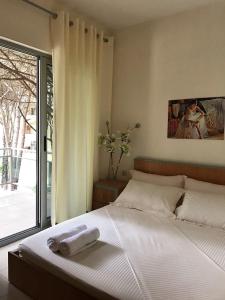 a bedroom with a bed with two towels on it at Intea Hotel in Golem