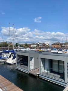 a house on the water with boats in a marina at Rooms at The Deck, Penarth in Cardiff