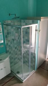 a shower with a glass door in a bathroom at Hotel Doria in Chiavari