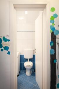 a bathroom with a white toilet in a room at Apartman Mia in Palit +26 photos