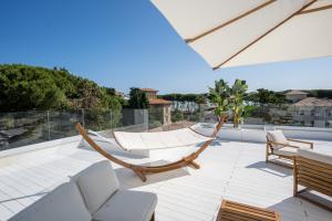 a patio with two hammocks on a roof at Villa Mare Pineto in Pineto